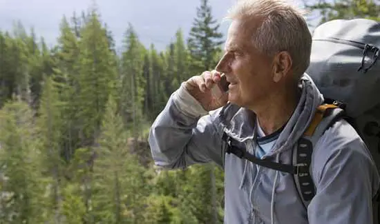 Man talking on the phone while hiking - cell phone is a great tool in SHTF communication