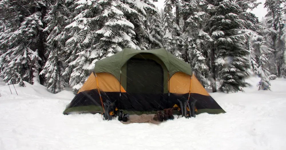 keeping warn in a waterproof tent in the snow